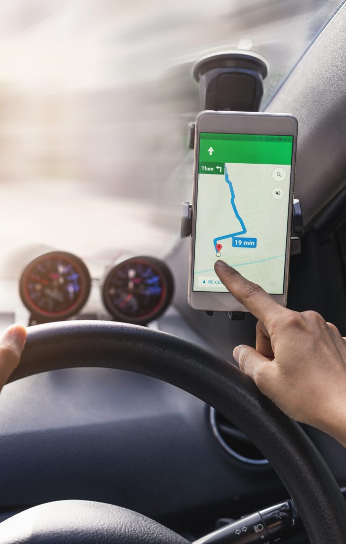 woman using gps navigation map on smartphone in car